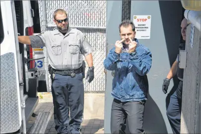  ?? CAPE BRETON POST PHOTO ?? Convicted murderer Brandon James Berthiaume, 26, of Ben Eoin, gives a news photograph­er a one-finger salute Monday as he was led from the Sydney Justice Centre. Berthiaume will now serve a life sentence after pleading guilty to the second-degree murder...