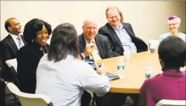  ?? Hearst Connecticu­t Media file photo ?? Federal Reserve Bank of Boston President Eric Rosengren talks with the Middletown Working Cities Challenge team, which includes over 20 organizati­ons dedicated to increasing the earning power of single-parent households.