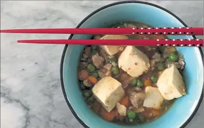  ?? ORANGE COUNTY REGISTER ?? Mapo Tofu features ground turkey, peas and carrots, but the starring attraction is large cubes of tofu.