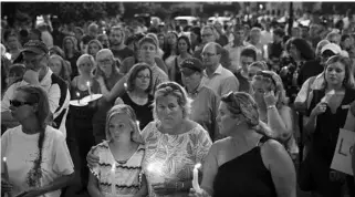 ?? PATRICK SEMANSKY/ASSOCIATED PRESS ?? Mourners stand in silence during a vigil Friday in response to Thursday’s shooting at the Capital Gazette.