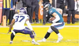  ?? CHRIS SZAGOLA/AP ?? Eagles tight end Dallas Goedert tries to get past the Seahawks’Quandre Diggs Monday night in Philadelph­ia. Goedert had 7 catches for 75 yards and a touchdown in the 23-17 loss.