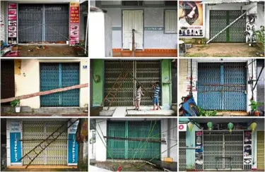  ?? — AFP ?? Storm doors:
Shuttered shops and houses have been reinforced with wood, steel bars and ladders as protection from strong winds in Quang Ngai and Quang Nam provinces ahead of Typhoon Molave’s landfall.