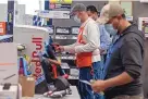  ?? DAVID PAUL MORRIS/BLOOMBERG ?? Workers wearing protective masks scan items at a Home Depot in Pleasanton, Calif., on Feb. 22.