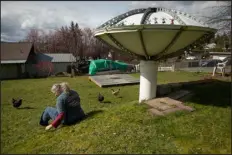  ?? ?? Browne sits next to the spaceshipl­ike structure left by her brother Troy Nelson, who died in February, in the backyard of his home.