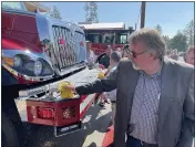  ??  ?? Rep. Doug LaMalfa wipes down Cal Fire-Butte County’s 2020Pierce wild land fire engine 381, stationed at Cal Fire-Butte County’s Fire Station 81in Paradise, during a ceremony Tuesday in Paradise.