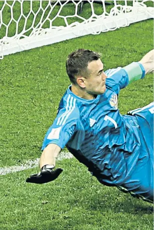  ??  ?? Russian hero: Igor Akinfeev saves from Iago Aspas to win the penalty shoot-out