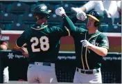  ?? PHOTO BY JOHN MEDINA ?? A’s first baseman Matt Olson, left, celebrates after hitting a homerun during the Athletics 9-3 win over the Giants.