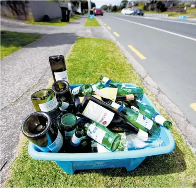  ?? Photo / George Novak ?? Glass recycling crates are back but don’t overfill.