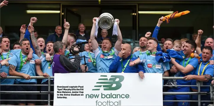  ??  ?? Overjoyed captain Paul ‘Spot’ Murphy lifts the FAI New Balance Junior Cup in the Aviva Stadium on Saturday.