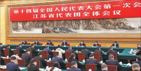  ?? HUANG JINGWEN / XINHUA ?? President Xi Jinping, who is also general secretary of the Communist Party of China Central Committee and chairman of the Central Military Commission, takes part in a deliberati­on with deputies from the delegation of Jiangsu province at the first session of the 14th National People’s Congress in Beijing on March 5.