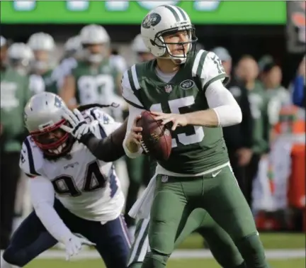  ?? SETH WENIG — THE ASSOCIATED PRESS ?? New York Jets quarterbac­k Josh McCown (15) looks to pass during the first half of an NFL football game as New England Patriots defensive end Adrian Clayborn (94) rushes him Sunday, Nov. 25, 2018, in East Rutherford, N.J.