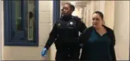  ?? CARL HESSLER JR. — MEDIANEWS GROUP ?? Gwendolyn Prebish is escorted from Montgomery County courtroom during break at her trial on charge of drug delivery resulting in death in connection with the November 2016 overdose death of Michael Pastorino, 32, of the Willow Grove section of Upper Moreland.