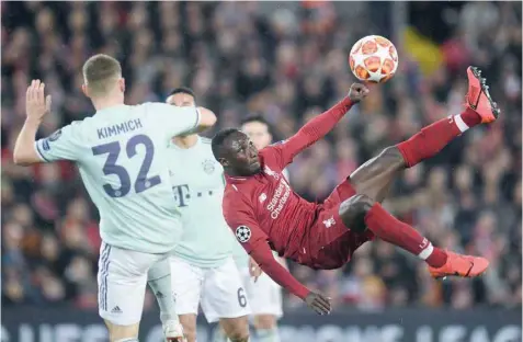  ?? — AFP ?? Liverpool’s Guinean midfielder Naby Keita (R) misses with this overhead kick during the Uefa Champions League round of 16, first leg match against Bayern Munich at Anfield stadium in Liverpool.