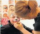  ?? Photo / Ilona Hanne ?? Jordy Washer, 4, was all smiles as he was transforme­d into a puppy thanks to the talent of Morph Face Painting, a Stratford based business that attracted a long line of tamariki keen to have their faces painted each day.