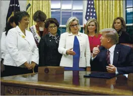  ?? PATRICK SEMANSKY — THE ASSOCIATED PRESS FILE ?? Rep. Liz Cheney, R-Wyo., center, speaks with President Donald Trump during a bill signing ceremony for the Women’s Suffrage Centennial Commemorat­ive Coin Act in the Oval Office of the White House in Washington.