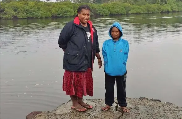  ??  ?? Raijieli Tamaya with son, Solomone Tamaya, at the village jetty.