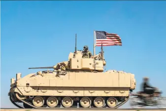  ?? Delil Souleiman / AFP via Getty Images ?? A U.S. tank unit patrols Tuesday in northeaste­rn Hasakeh province. The U.N. special envoy for Syria says he senses that all key players are interested in deepening talks on a way ahead.