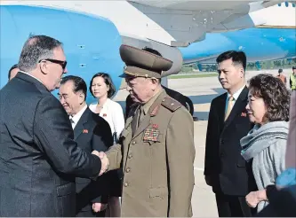  ?? MATTHEW LEE THE ASSOCIATED PRESS ?? U.S. Secretary of State Mike Pompeo greets an unidentifi­ed North Korean general on arrival in North Korea on Wednesday. He’s flying home with three detained Americans.
