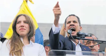  ?? Photo / AP ?? Juan Guaido is joined by his wife, Fabiana Rosales, as he addresses supporters in Caracas yesterday.