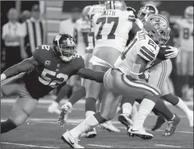  ?? AP/MICHAEL AINSWORTH ?? New York Giants linebacker Jonathan Casillas (52) attempts to stop Dallas Cowboys running back Ezekiel Elliott (21) from gaining yardage on a run in the second half of an NFL football game Sunday in Arlington, Texas.