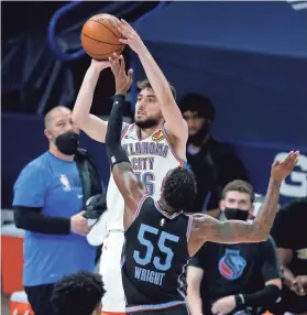  ?? SARAH PHIPPS/THE OKLAHOMAN ?? Oklahoma City's Ty Jerome (16) shoots as Sacramento's Delon Wright (55) defends in the third quarter of the Kings' 103-99 win Tuesday.