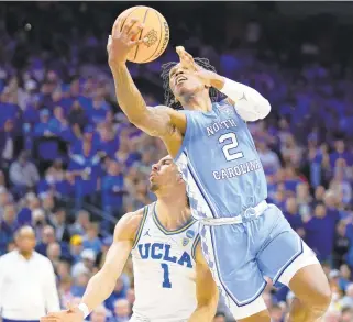  ?? MATT ROURKE/AP ?? North Carolina guard Caleb Love goes up for a shot against UCLA guard Jules Bernard during Friday night’s East Region semifinal in Philadelph­ia. Love scored 27 of his career-high 30 points in the second half.