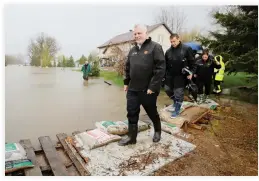  ??  ?? Quebec Premier Philippe Couillard tours a flooded residentia­l area in Rigaud, Quebec, on Saturday. (Reuters)