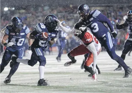  ?? PAUL CHIASSON/THE CANADIAN PRESS ?? Toronto Argonauts defensive back Cassius Vaughn, centre left, recovers the football on a fumble by Calgary Stampeders slotback Kamar Jorden, centre right, during the second half of the 105th Grey Cup on Sunday in Ottawa. Vaughn had a 109-yard play...
