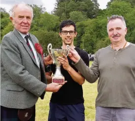  ??  ?? Trophy time Dr Niku Dhillon, centre, receives the Dan Webster Cup for best light athlete from Sir Michael Nairn, left, and race starter Niven Duncan