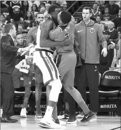  ??  ?? Golden State Warriors forward Draymond Green (left) and Washington Wizards guard Bradley Beal fight during the second quarter at Oracle Arena. — USA TODAY Sports photo