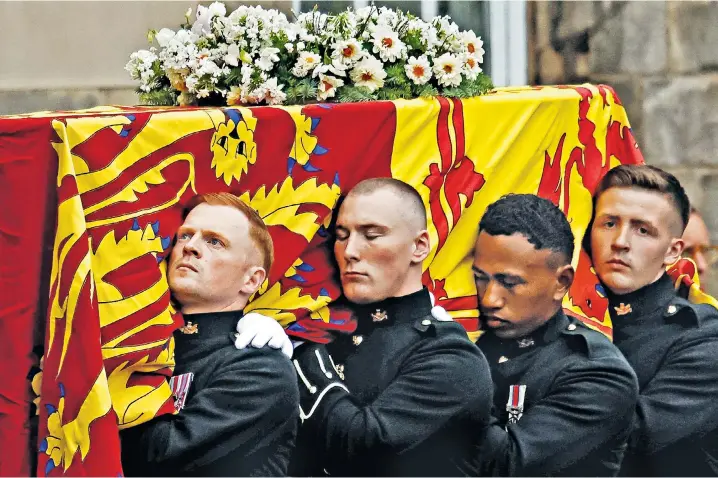  ?? ?? Military bearers from the Royal Regiment of Scotland carry the Queen’s coffin into the Throne Room at the Palace of Holyroodho­use