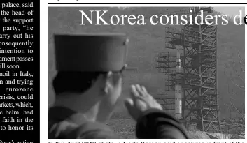  ??  ?? In this April 2012 photo, a North Korean soldier salutes in front of the country’s Unha-3 rocket, slated for liftoff between April 12-16, at Sohae Satellite Station in Tongchang-ri, North Korea.