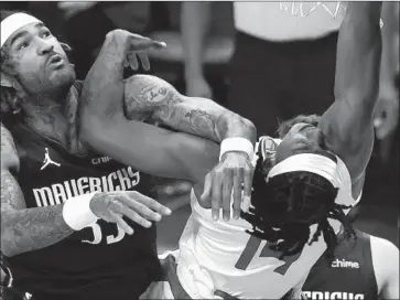  ?? Ronald Martinez Getty Images ?? TERANCE MANN absorbs a foul from Dallas’ Willie Cauley-Stein in the first quarter of Game 3.