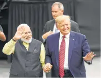  ?? Steve Gonzales / Staff photograph­er ?? Modi and Trump walk around the stadium. Modi said Trump “is firmly committed to fighting this battle against terrorism,” a reference to Pakistan, India’s longtime enemy.
