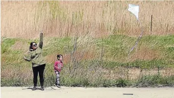  ?? DAVID BEBEE WATERLOO REGION RECORD FILE PHOTO ?? A woman and her daughter fly a kite while exploring trails in the Chicopee area of Kitchener.