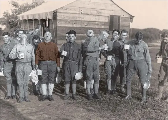  ?? SHUTTERSTO­CK ?? Soldiers gargle with salt and water to prevent influenza, Sept. 24, 1918. Camp Dix, New Jersey, during the 1918-19 influenza pandemic.