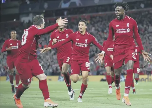  ??  ?? 0 Divock Origi, right, celebrates after score the fourth goal in Liverpool’s sensationa­l comeback win over Barcelona at Anfield.