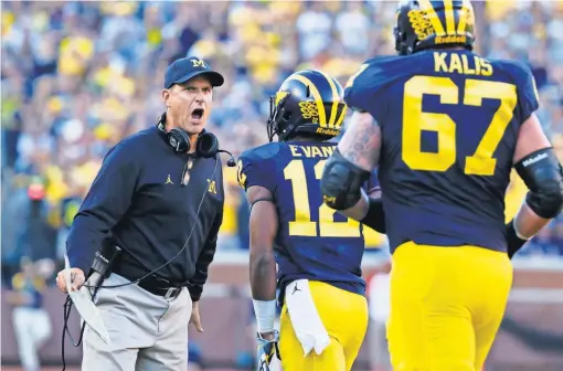  ?? RICK OSENTOSKI, USA TODAY SPORTS ?? Coach JimHarbaug­h, left, and No. 5 Michigan play host to No. 8Wisconsin on Saturday looking to improve to 5- 0 this season. TheWolveri­nes are coming off a 49- 10 blowout of Penn State.
