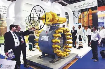  ?? Abdul Rahman/Gulf News ?? Visitors look at Hawa valves from India at their pavilion at Adipec yesterday at ADNEC.