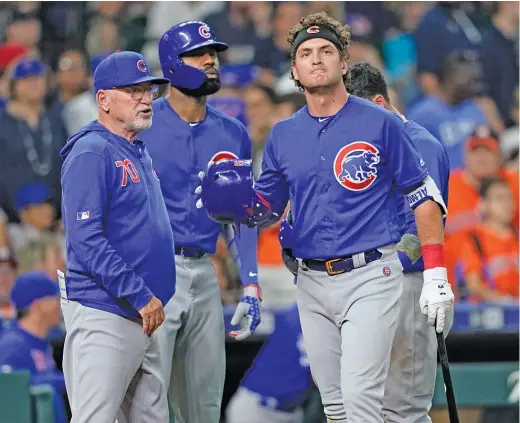  ?? DAVID J. PHILLIP/AP ?? Cubs outfielder Albert Almora Jr. (right) reacts to the news that a foul ball he hit into the stands struck and badly injured a young child last May 29 in Houston.