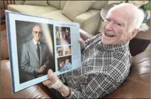  ?? Dan Watson/ The Signal ?? Myron Sproul shows a portrait of himself in the 1984 Saugus yearbook, at his home in Valencia in September 2019.