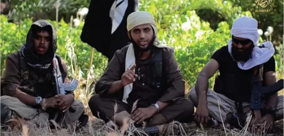  ??  ?? Recruiting: Nasser Muthana (centre), a medical student from Cardiff, in the video urging British Muslims to join ISIS militants in Iraq and Syria