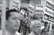  ?? Rick Loomis Los Angeles Times ?? DEMONSTRAT­ORS attend a meeting on wage theft last month at Franklin High School. New legislatio­n would give the state new powers to recover back pay.