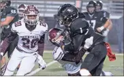  ?? Bambara Aven, @avenphoto ?? Ridgeland’s Darrian Burks is met by a Central defender after making a catch against the Lions on Friday night. Burks had five receptions for 102 yards in the season finale in Rossville.