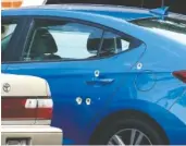  ?? STAFF PHOTO BY C.B. SCHMELTER ?? Bullet holes are seen on a vehicle parked at the Hamilton Pines apartment complex on Tuesday. A shooting in the 3300 block of Pinewood Avenue left one person dead, Chattanoog­a police said.