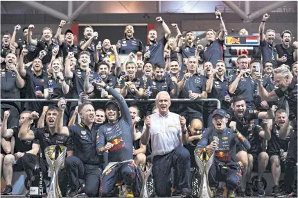  ?? AFP ?? Red Bull driver Max Verstappen, front right, and team members celebrate after the Abu Dhabi Grand Prix.