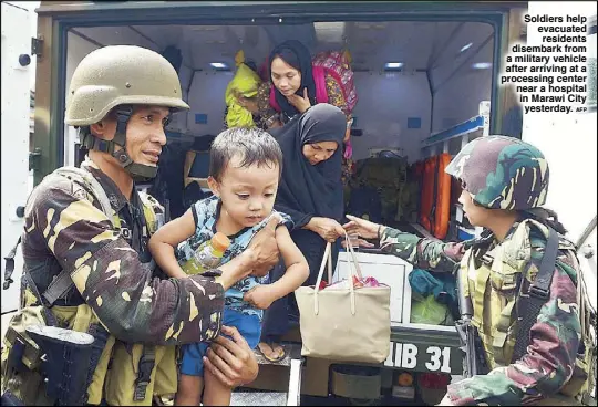  ?? AFP ?? Soldiers help evacuated residents disembark from a military vehicle after arriving at a processing center near a hospital in Marawi City yesterday.