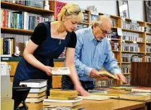  ?? COURTESY ?? Manager Alexa Dunford and bookseller Alfred “Mr. Barney” Barnhart organize books at the Marietta Book Nook.