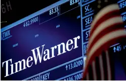  ?? Reuters ?? Ticker and trading informatio­n for media conglomera­te Time Warner is displayed at the post where it is traded on the floor of the New York Stock Exchange (NYSE) in New York City. —