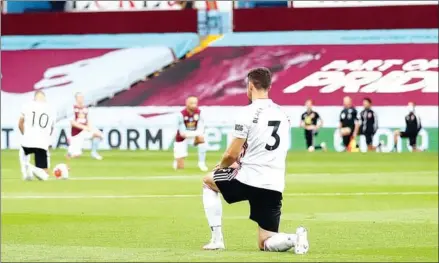  ?? AFP ?? Sheffield United’s Enda Stevens kneels during a moment of silence before the team’s Premiere League match with Aston Villa. After the protest against racism, the League’s first game back was chaotic when goal-line technology faltered.